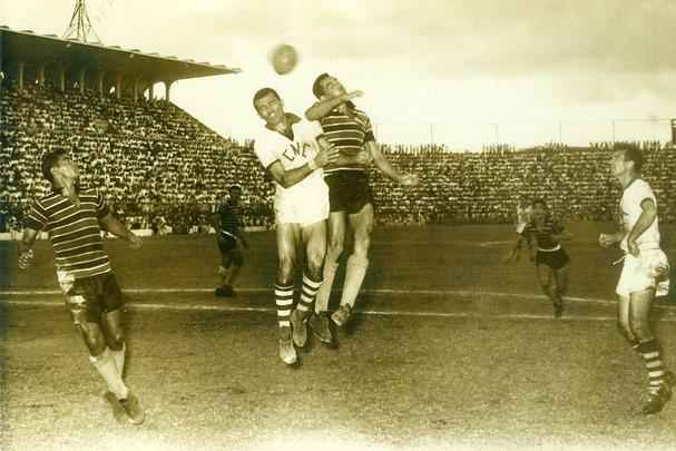 1959 - Os dois clubes voltaram a decidir o título Estadual e o Náutico poderia conquistar o oitavo título e igualar ao Tricolor em taças, mas o Santa levou a melhor novamente. A série de melhor de três jogos começou com empate em 1 a 1, na Ilha, e terminou em dois jogos nos Aflitos, com uma vitória coral por 2 a 1 e um empate sem gols. Na foto, Rudimar, do Santa Cruz disputa a bola com Lula, do Náutico.